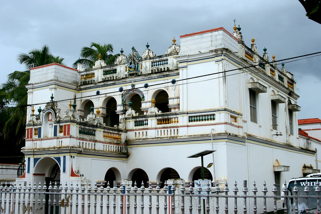 A palatial Chettinad house with ornate columns and colourful architectural details
