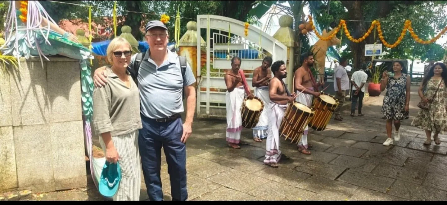 Visitors beside traditional Kerala drummers