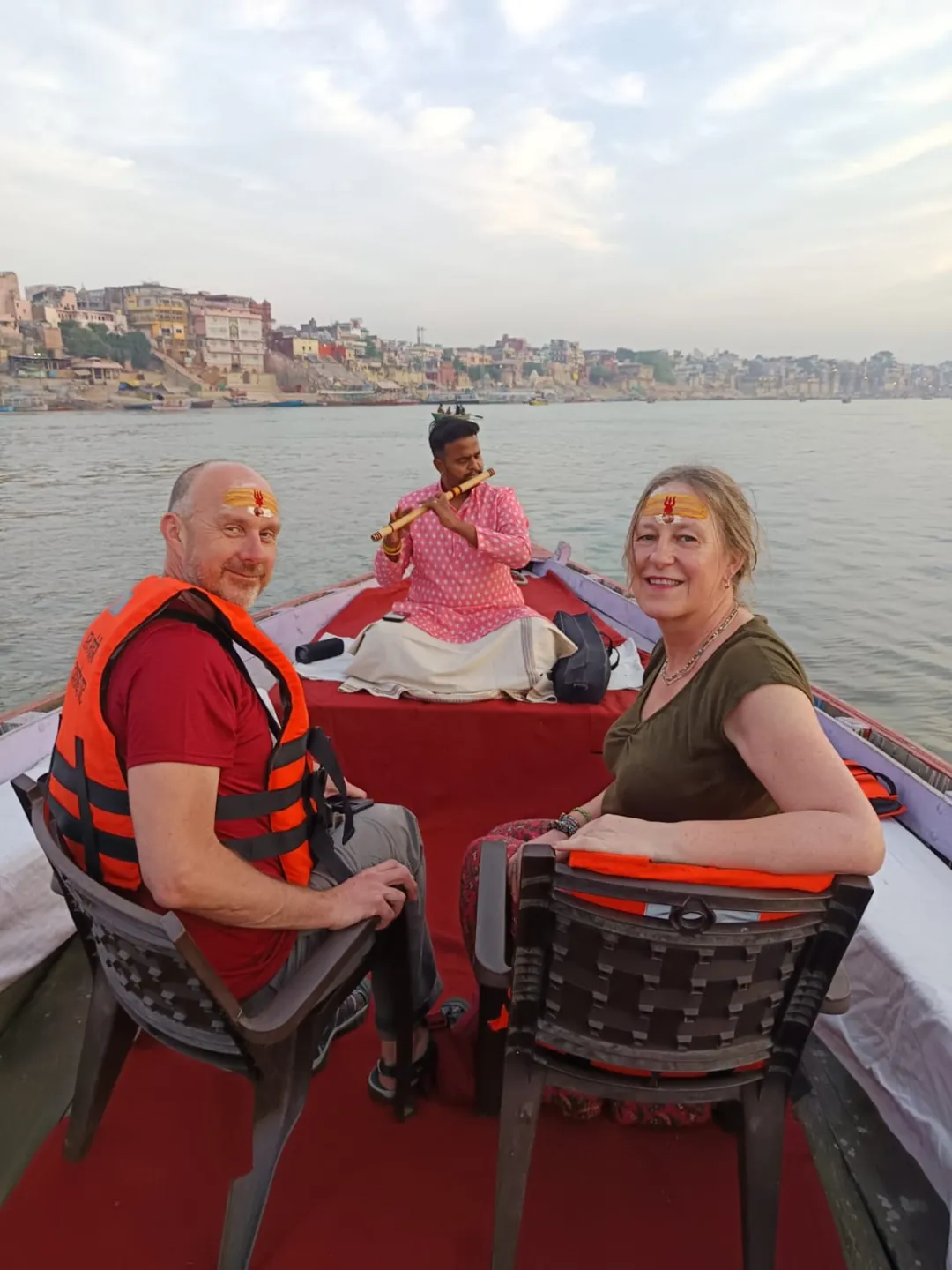 Travellers enjoying the riverfront view from a boat in Varanasi